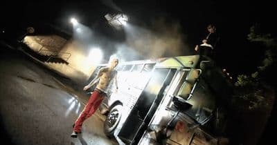 a group of people standing on top of a bus