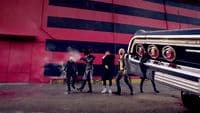 a group of people standing next to a car