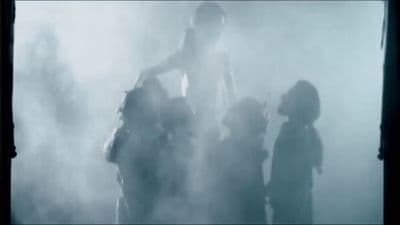 a group of people standing in a foggy area