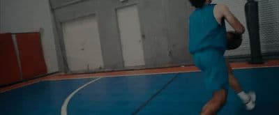a man in a blue uniform is playing basketball
