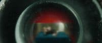 a reflection of a man in a toilet bowl