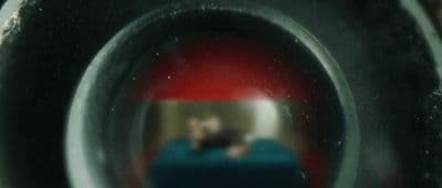 a reflection of a man in a toilet bowl