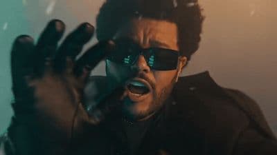 a man wearing sunglasses making a face with his hands