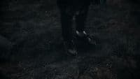 a person walking in the dark with their shoes on