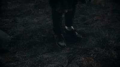 a person walking in the dark with their shoes on