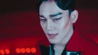 a man with black hair and a red shirt