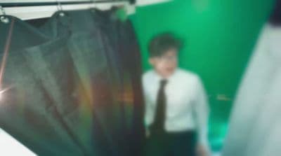 a man standing in front of a green screen