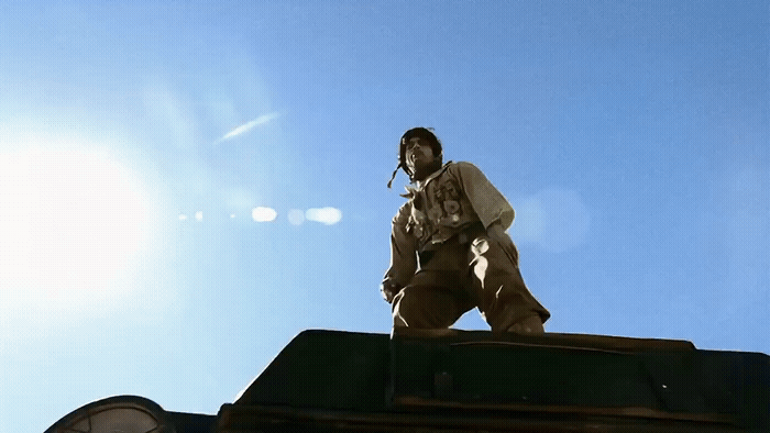 a man standing on top of a building next to a clock