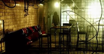a dimly lit room with chairs and a table