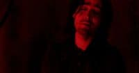 a man with his eyes closed in a dark room