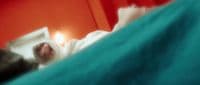 a blurry image of a cat laying on a bed