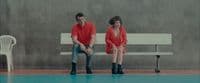 a man and a woman sitting on a bench