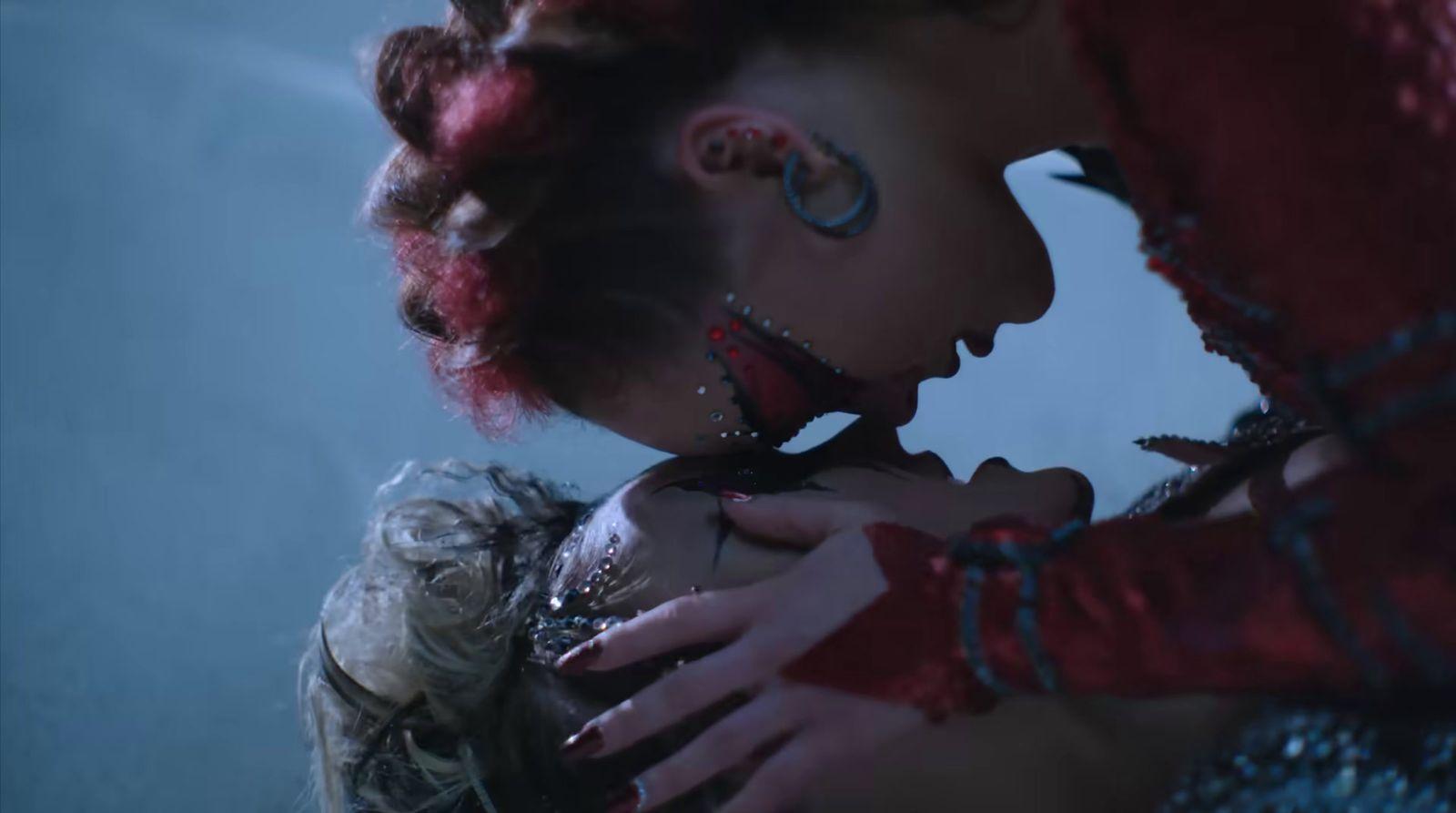 a woman with red hair and piercings on her face