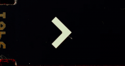 a close up of a street sign with a white arrow