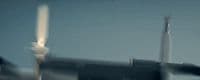 a plane is flying in the sky with a blurry background