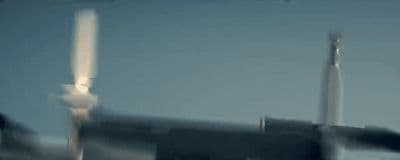 a plane is flying in the sky with a blurry background