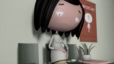 a little girl with black hair standing next to a table