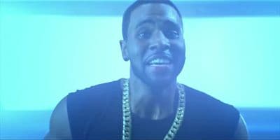 a man wearing a black shirt and a chain around his neck