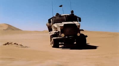 a military vehicle driving through the desert