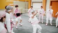 a group of people in white and pink outfits