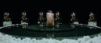 a group of naked men sitting on top of a stage