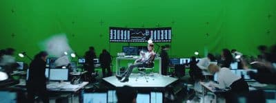 a group of people standing around a green screen