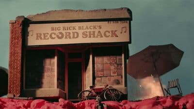 an old record shack with a bicycle parked outside