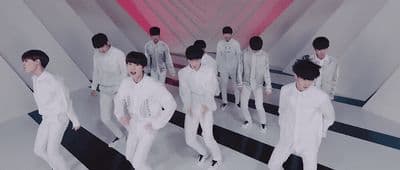 a group of young men in white suits