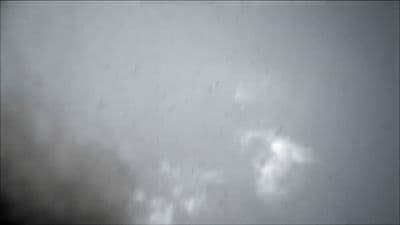 a black and white photo of a plane in the sky