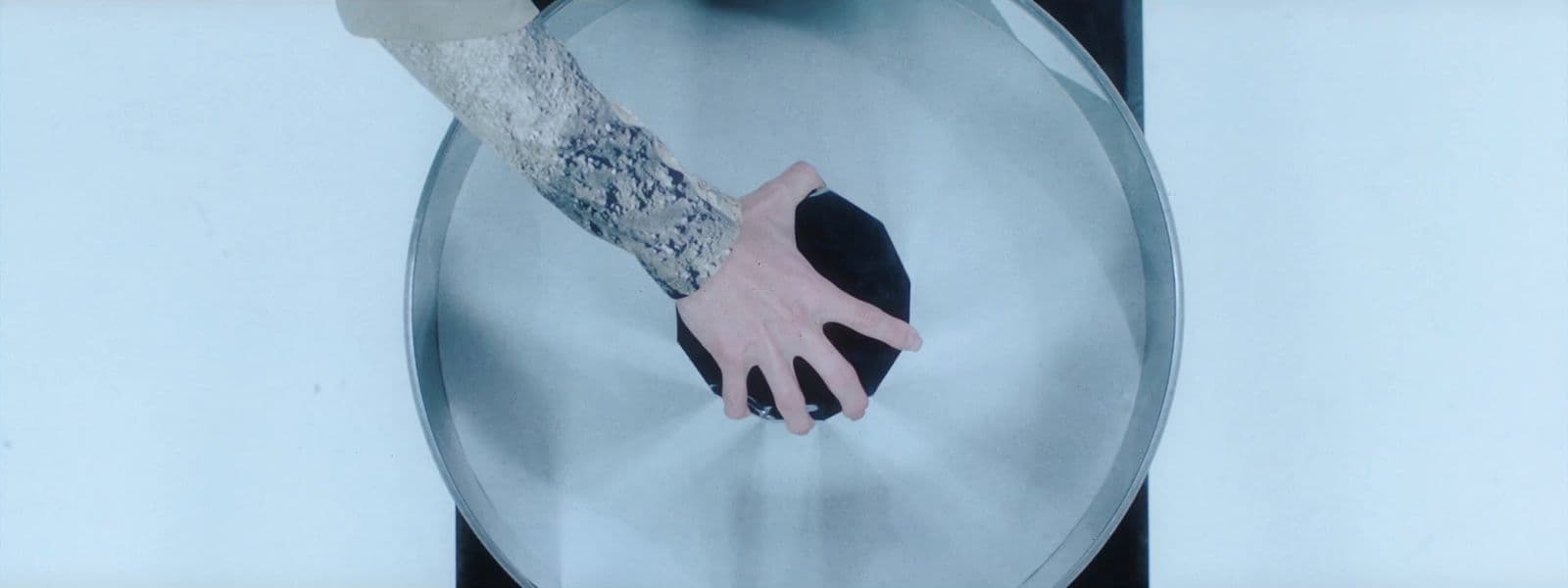 a person's arm and hand on a toilet seat