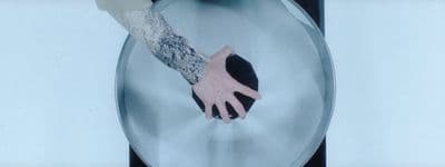 a person's arm and hand on a toilet seat