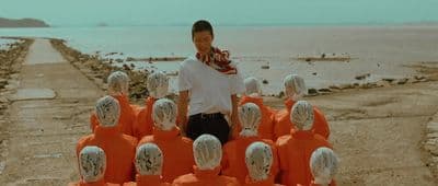 a man standing in front of a group of mannequins