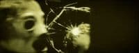 a blurry photo of a person holding a broken glass