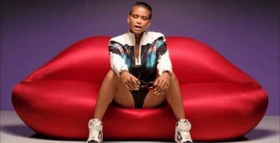 a woman sitting on top of a red couch