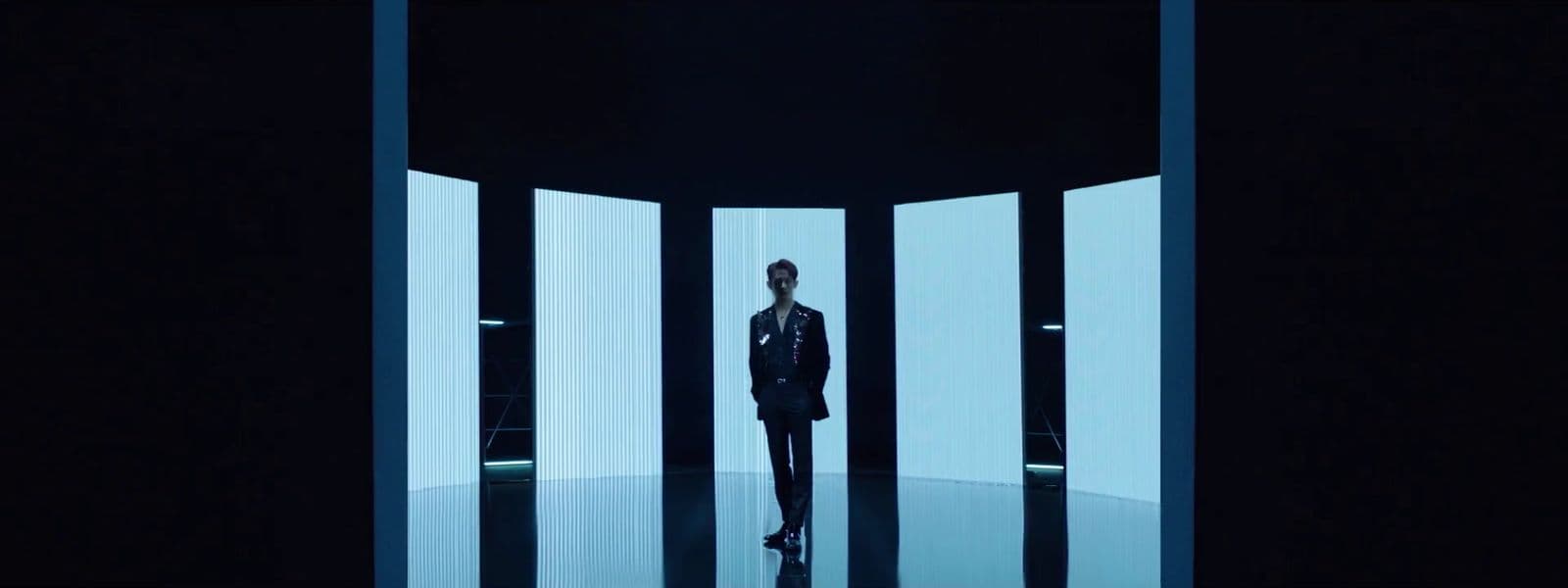 a man standing in a doorway in a dark room