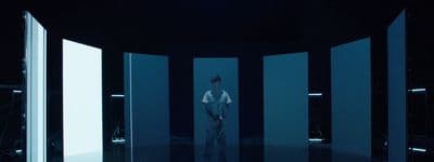 a man is standing in a room with white walls
