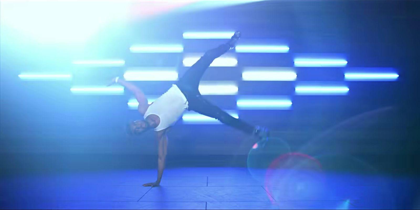 a person on a stage doing a trick with a tennis racket