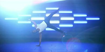 a person on a stage doing a trick with a tennis racket