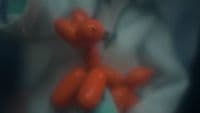 a person holding a bunch of red balloons