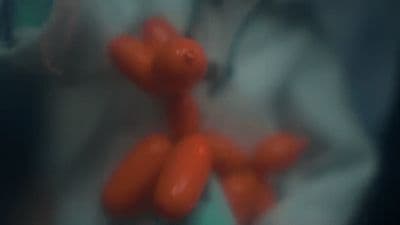 a person holding a bunch of red balloons