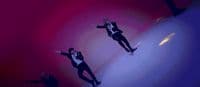 a man in a tuxedo jumping in the air