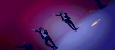 a man in a tuxedo jumping in the air