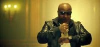 a man in a leather jacket holding a bottle