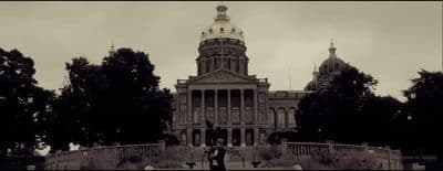 a black and white photo of a building with a clock tower