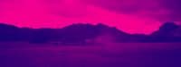 a truck is parked in a field with mountains in the background
