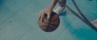 a person holding a basketball on a court