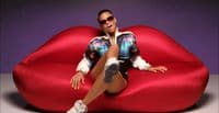 a woman sitting on top of a red couch