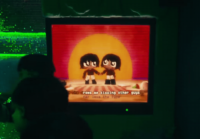 a person standing in front of a flat screen tv