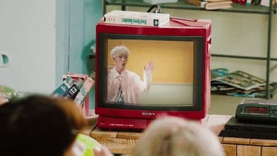 a television with a person on it in a room
