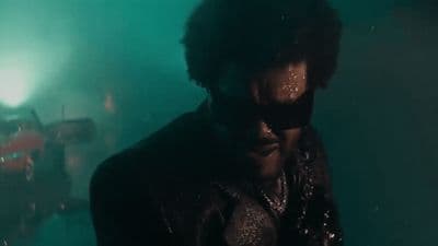 a man in a black leather jacket and sunglasses